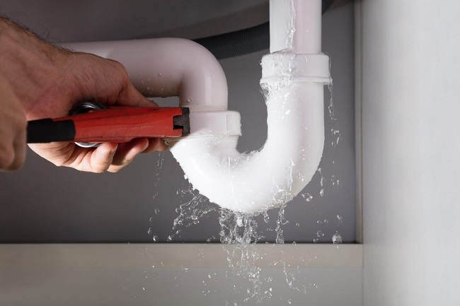 plumber working on pipes